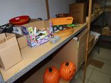 two orange pumpkins sitting on a shelf in a room