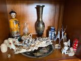 a wooden shelf with a vase, vase, and other items on it