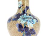 a vase with a blue flower on it sitting on a table