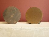 two pieces of pottery sitting on top of a table