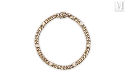 a close up of a gold chain bracelet on a white background