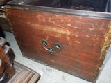 an old wooden chest with a metal latch on it