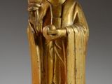 an image of a gold statue of a person holding a bird
