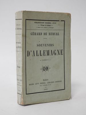an old book sitting on top of a table on a white surface