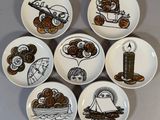 six plates with different designs on them sitting on a table