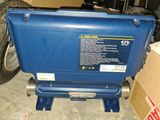 an image of a blue cooler sitting on top of a box