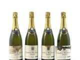 trois bouteilles de champagne posées les unes à côté des autres sur une surface blanche