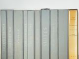 several books are stacked on top of each other on a table