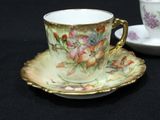 a cup and saucer sitting on a black table