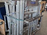 a cart that has a bunch of metal pipes on it