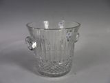 a clear glass vase with a handle on a table