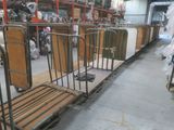 many metal beds lined up in a warehouse
