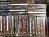 a lot of dvds on a glass shelf in a room