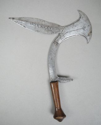 a metal knife with a wooden handle hanging on a wall