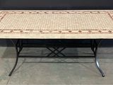 a table with a mosaic tile top and metal legs