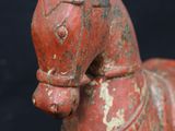an old red wooden toy horse on a black background