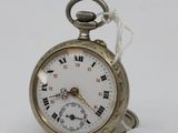 a silver pocket watch with roman numerals on it