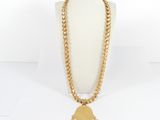 a gold chain necklace with a gold hand charm hanging from it
