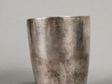pair of silver cups on a grey surface