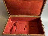 a small wooden box with a red lining inside