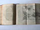 an open book with a drawing on it sitting on a table