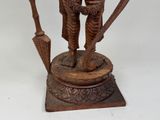 statue of a man and a woman holding a sword on a pedestal