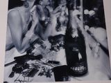 a black and white photo of a woman drinking a bottle of wine