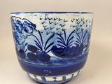 a blue and white bowl with a fish design on it