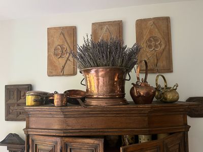 a wooden cabinet with a potted plant on top of it