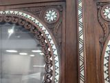 two wooden doors that have decorative designs on them