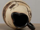 a black and white vase sitting on a table