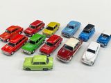 several toy cars are lined up in a row on a white surface