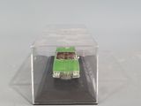 a green toy car in a clear box on a table