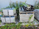 a pile of concrete blocks sitting on a pallet next to a wall