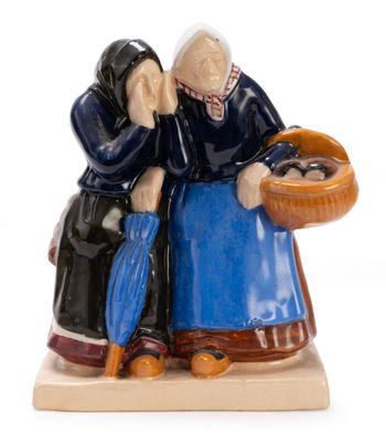 two figurines of two women sitting on a table