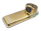 a cell phone with a gold case and a watch on it