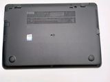 the back of a laptop with a small battery on top of it