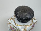 a vase with a lid that has a design on it