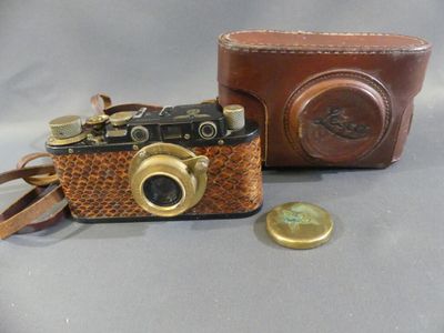 a brown camera and a brown case on a table