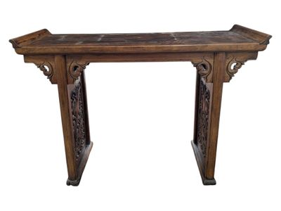 an old wooden table with carvings on the top of it