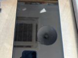 a person taking a picture of a cell phone on a table