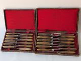 six knives in a case on a white surface