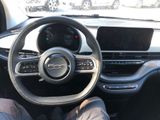 someone is sitting in the driver ' s seat of a car with their feet on the steering wheel