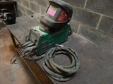 a welder that is sitting on a table with a hose