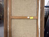 an old wooden easel with a piece of fabric on top of it