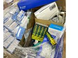 a pile of electronic equipment in a box on the floor