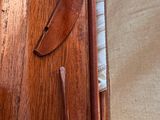 a close up of a piece of wood with a knife on it