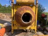 a yellow machine that is sitting in the middle of a field