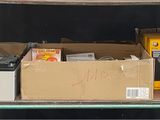 many boxes and boxes on a shelf in a room