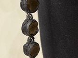 a close up of a necklace on a mannequin mannequin